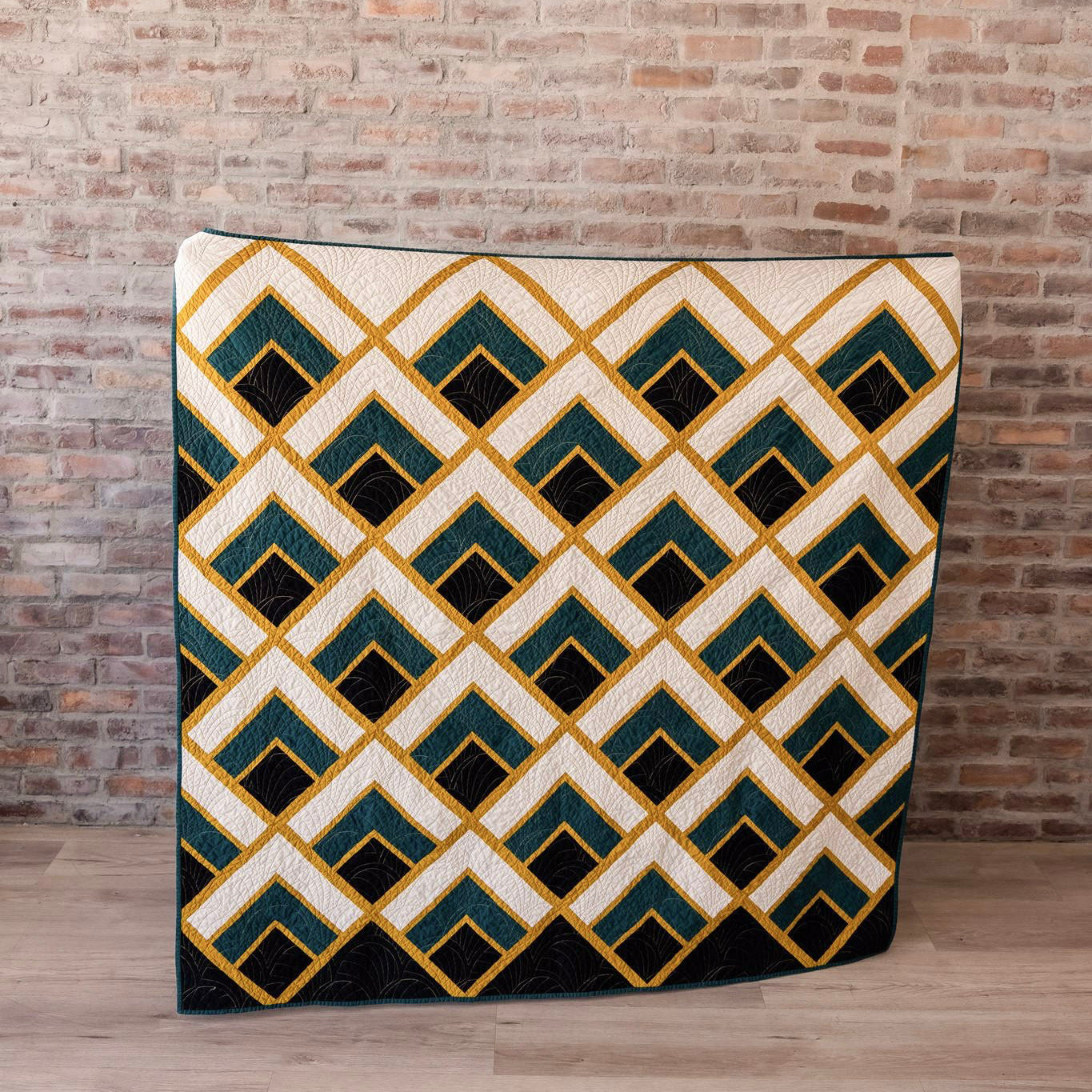 Decorative rug with geometric pattern in front of a brick wall