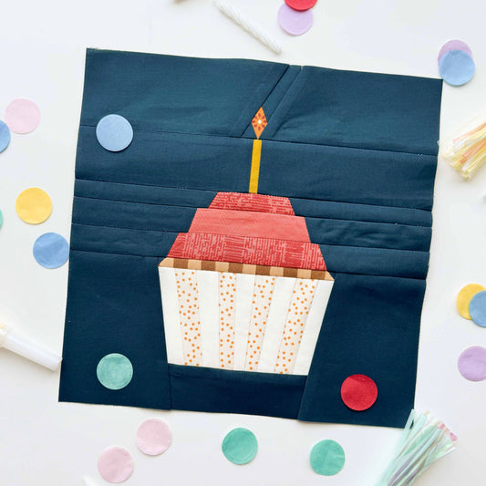 Patchwork square with a cake design on a white background with colorful confetti